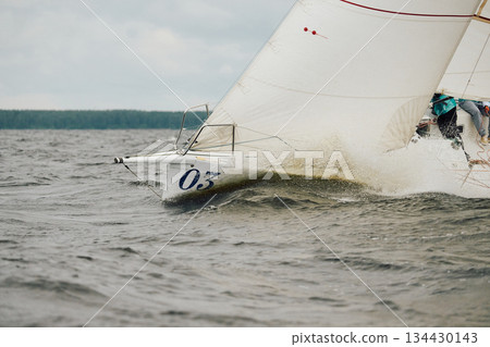 bow of a sailing boat with bowsprit at sailing regatta in the Gulf of Finland at sunny day, sailing yacht competing in a race, splashing water from under the boat, teamwork, board the boat 134430143