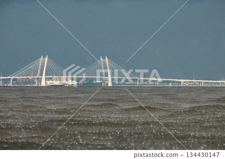 cable-stayed bridge and hydrofoil boat in the background, water surface of the Gulf of Finland in heavily rain, raindrops, storm, Russia, Saint-Petersburg 134430147