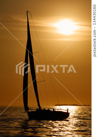 Sailing regatta in the Gulf of Finland at sunset, few sailing yachts competing in a race, splashing water from under the boats, teamwork, board the boat 134430160