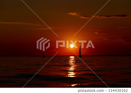 Sailing regatta in the Gulf of Finland at sunset, few sailing yachts competing in a race, splashing water from under the boats, teamwork, board the boat 134430162