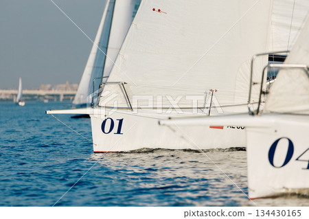 bow of a sailing boats with bowsprit at sailing regatta in the Gulf of Finland at sunny day, sailing yacht competing in a race, splashing water from under the boat, teamwork, board the boat bow of a sailing boats with bowsprit at sailing regatta in the Gulf of Finland at sunny day, sailing yacht competing in a race, splashing water from under the boat, teamwork, board the boat 134430165