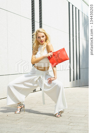 Fashion woman white outfit with red handbag Fashion woman white outfit with red handbag 134430203
