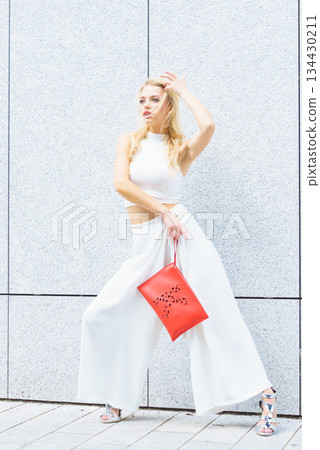 Fashion woman white outfit with red handbag Fashion woman white outfit with red handbag 134430211
