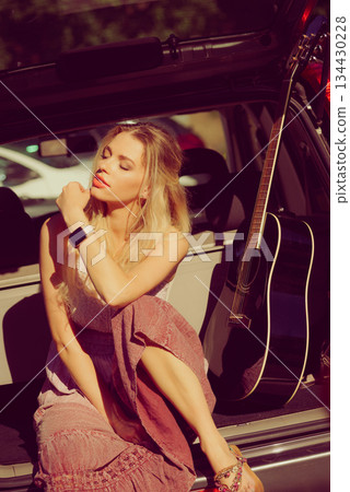 Hippie woman with guitar in van car 134430228