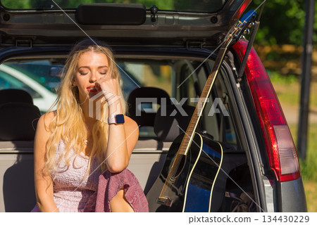 Hippie woman with guitar in van car Hippie woman with guitar in van car 134430229