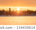 Golden winter sunset in Northern Europe with snowy forest and frozen lake 134430614