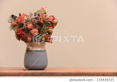 a bouquet of dried roses and wildflowers arranged in a handmade ceramic vase a bouquet of dried roses and wildflowers arranged in a handmade ceramic vase 134430725