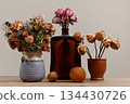 A quiet still life featuring dried floral arrangements 134430726