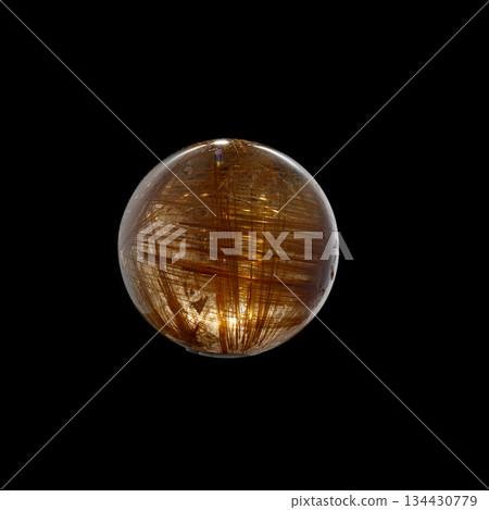 Ball of quartz with rutile on a black background 134430779