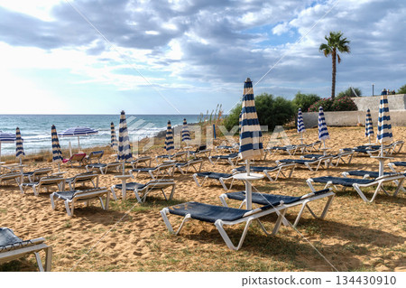 Sunny palm beach on Mediterranean seaside vacation. Sunny palm beach on Mediterranean seaside vacation. 134430910