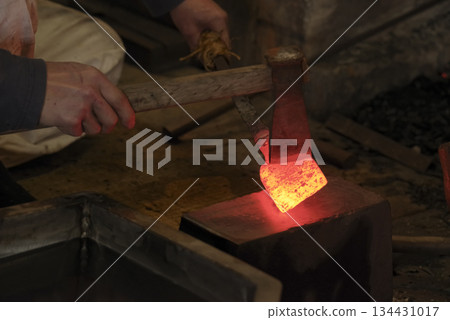 Red-hot steel being folded and forged Red-hot steel being folded and forged 134431017