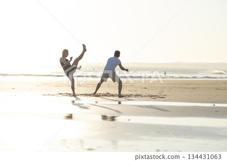People practicing capoeira martial art on beach People practicing capoeira martial art on beach 134431063