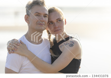 Loving couple embracing outdoors, sharing tender moment 134431078