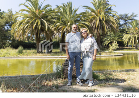 Senior couple standing together enjoying tropical park leisure 134431116