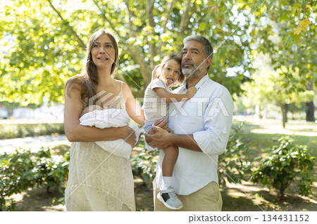 Happy mixed age family enjoying quality time outdoors together 134431152