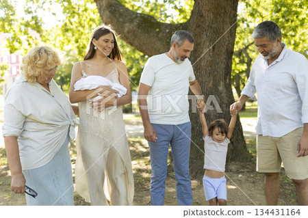 Multi generation family enjoying happy walk in park Multi generation family enjoying happy walk in park 134431164