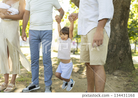 Happy kid playing outdoors supported by loving family Happy kid playing outdoors supported by loving family 134431168