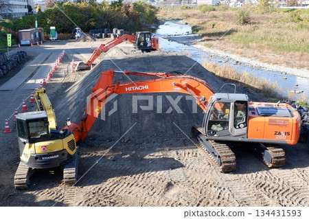 Backhoe at a river construction site 134431593