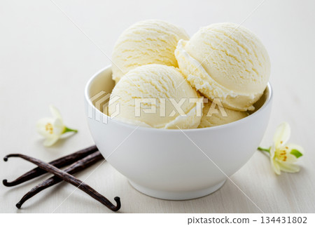 Close-up of a white bowl filled with three scoops of cookie vanilla ice cream, garnished with a cookies 134431802