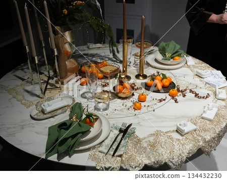 Celebration Table With Fruits And Candles, Decorative Dinner Setup With Fruits And Gentle Lighting Celebration Table With Fruits And Candles, Decorative Dinner Setup With Fruits And Gentle Lighting 134432230