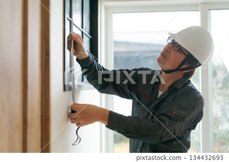 A man in his 50s wearing work clothes 134432693