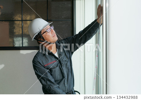 A man doing window maintenance 134432988