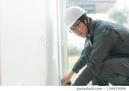 Man working on interior decoration Man working on interior decoration 134433006