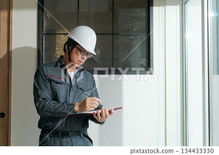 Worker checking window glass Worker checking window glass 134433330