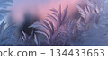 Frosted window with intricate ice patterns reflecting soft pastel colors at sunrise 134433663