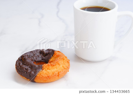 Donuts and Coffee - Chocolate-covered old-fashioned donuts and coffee Donuts and Coffee - Chocolate-covered old-fashioned donuts and coffee 134433665