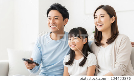 Family enjoying TV in the living room 134433876