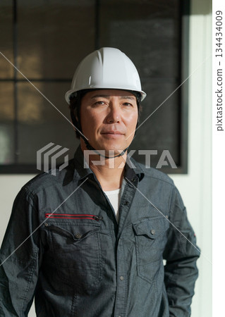A man in his 50s wearing work clothes A man in his 50s wearing work clothes 134434009