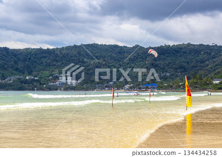 Patong Beach Phuket with people promenade turquoise blue water Thailand. Patong Beach Phuket with people promenade turquoise blue water Thailand. 134434258
