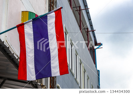 Thailand Thai flag blowing in the wind in the city. Thailand Thai flag blowing in the wind in the city. 134434300