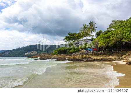 Rocky beach with rocks turquoise water palm trees Patong Thailand. Rocky beach with rocks turquoise water palm trees Patong Thailand. 134434497