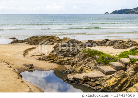 Rocky beach with rocks turquoise water palm trees Patong Thailand. Rocky beach with rocks turquoise water palm trees Patong Thailand. 134434509