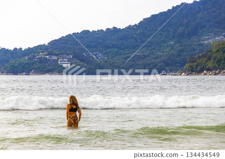 Patong Beach Phuket with people promenade turquoise blue water Thailand. 134434549