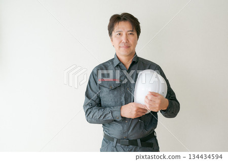 A man in his 50s wearing work clothes A man in his 50s wearing work clothes 134434594