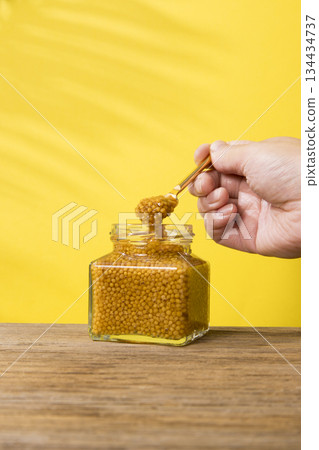 Scooping mustard Scooping mustard 134434737
