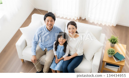 Family relaxing in their home living room 134434955