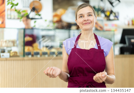 Portrait of friendly female cafe employee Portrait of friendly female cafe employee 134435147
