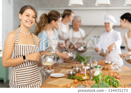 Young woman holding bowl in her hands Young woman holding bowl in her hands 134435273