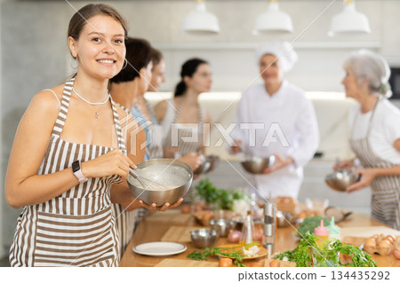 Young woman learns to cook at master class Young woman learns to cook at master class 134435292