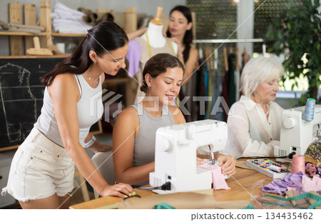 Group of women sew and work with mannequin at master class 134435462
