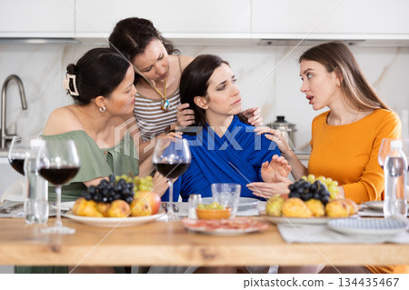 Female friends consoling upset bestie during friendly get-together Female friends consoling upset bestie during friendly get-together 134435467