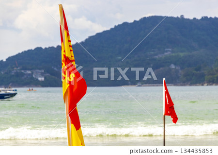 Patong Beach Phuket with red flag turquoise blue water Thailand. 134435853