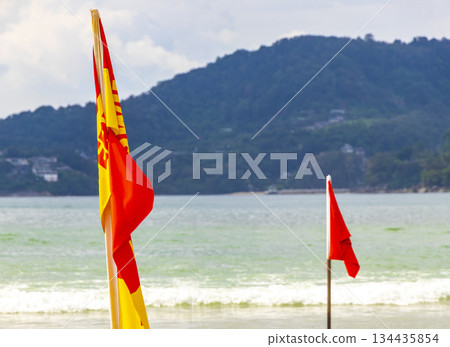 Patong Beach Phuket with red flag turquoise blue water Thailand. Patong Beach Phuket with red flag turquoise blue water Thailand. 134435854