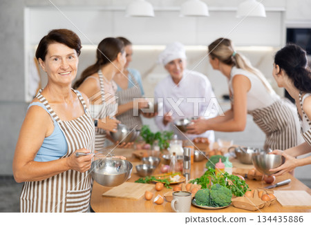 Elderly woman learns to cook at master class 134435886