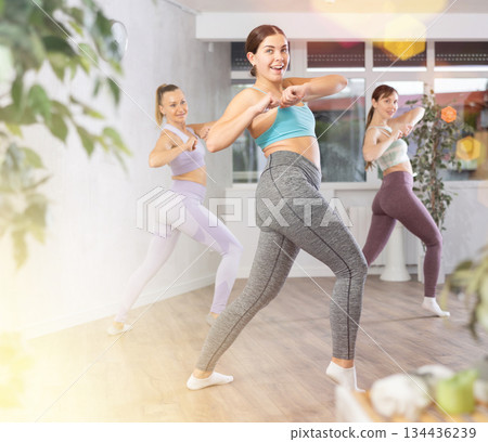 Positive women engaged in active dancing 134436239