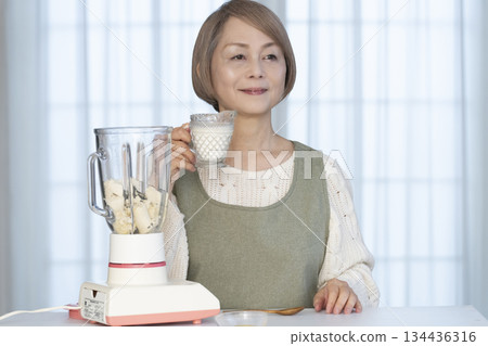 老婦人在廚房用果汁機製作健康果汁 134436316